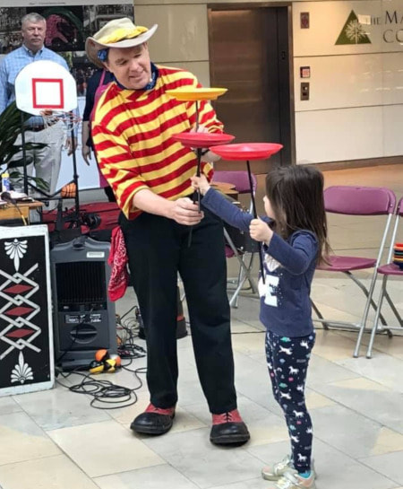 Gregory May Circus Show Volunteer with Spinning Plates